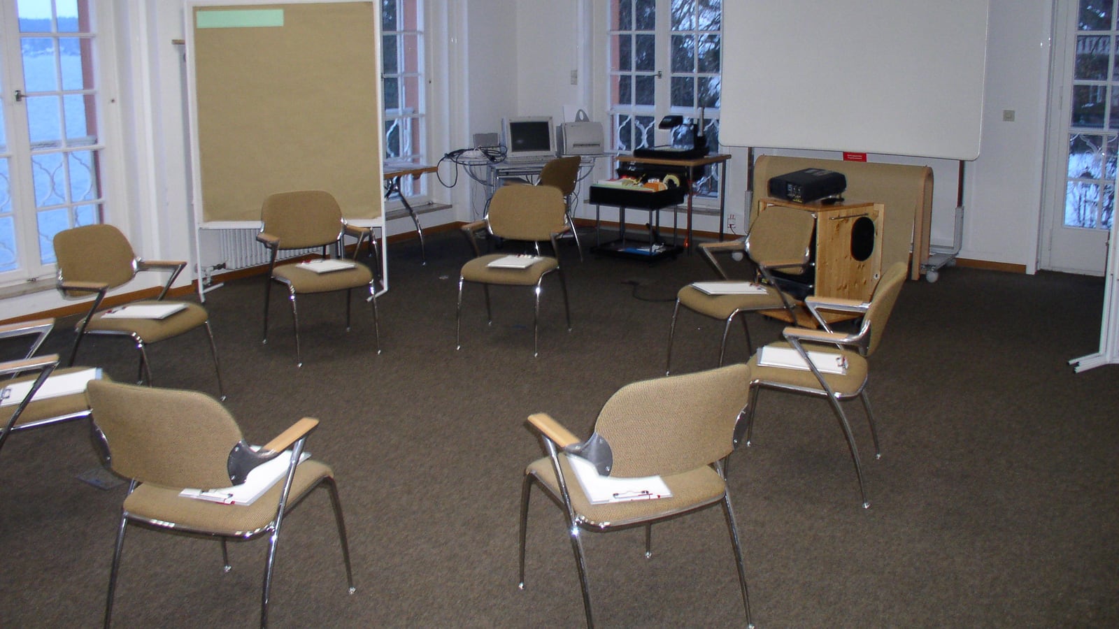 A circle of chairs prepared for a group workshop