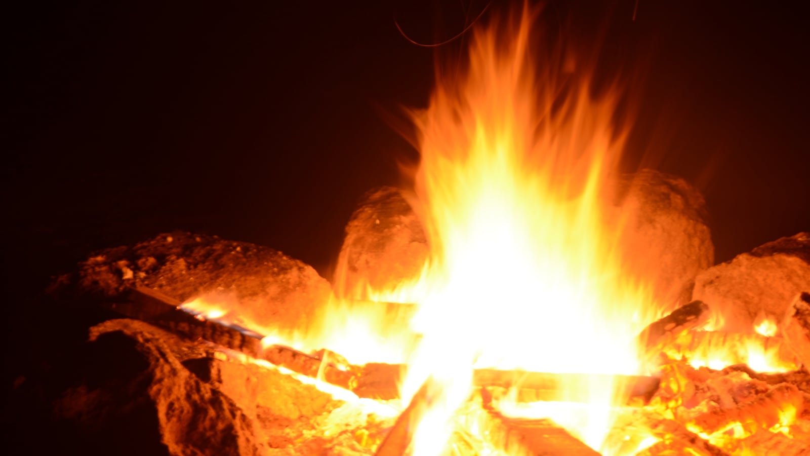 A scout campfire burning in the dark